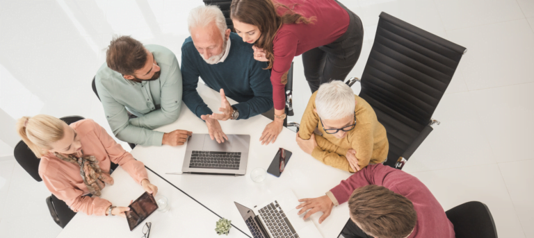 Picture of people working together to illustrate a blog piece on organizational silos, teamwork and silo working