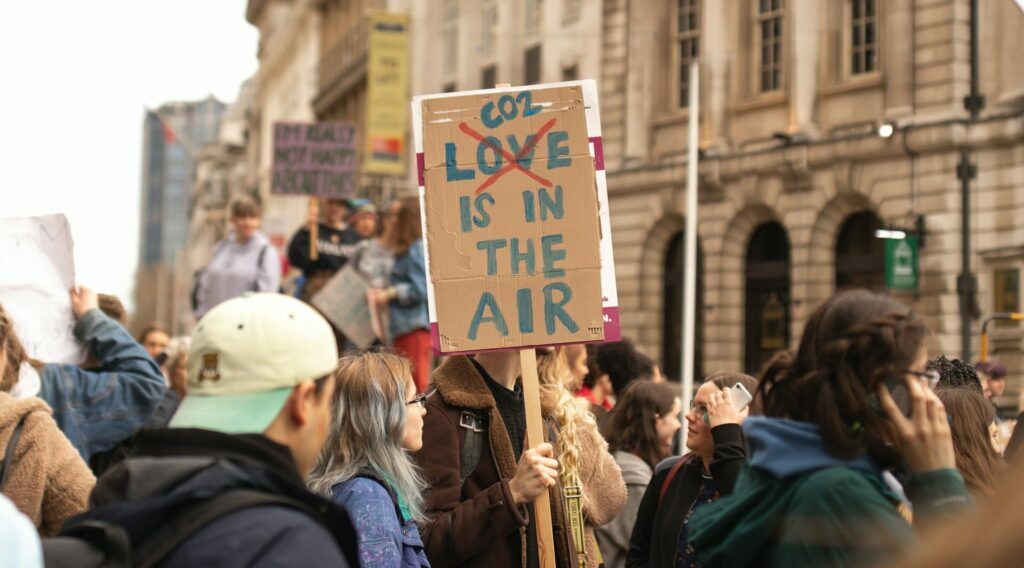 Protest on climate change with a sign saying "CO2 is in the air" to illustrate the blog piece on climate change, business sustainability and ESG.